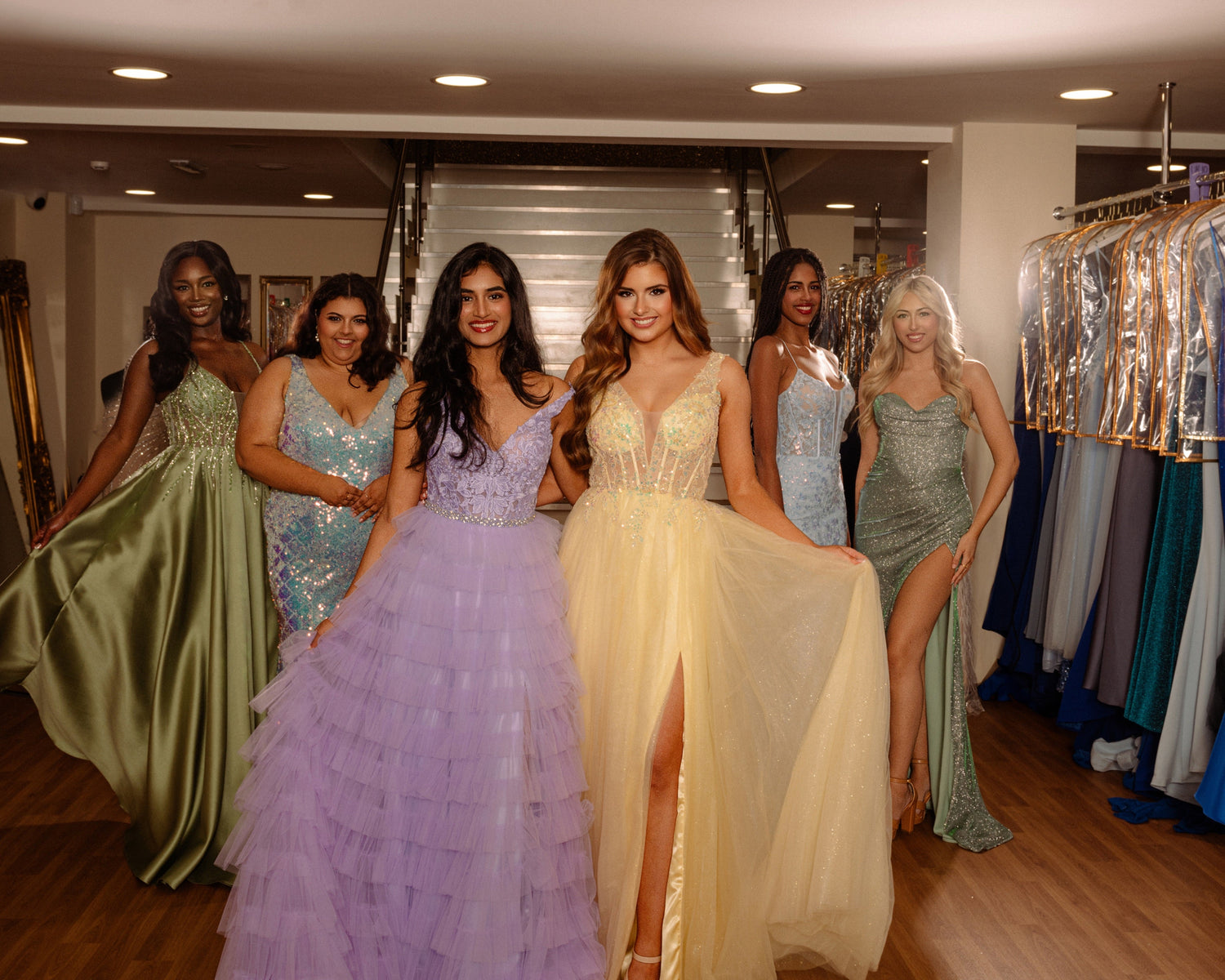 Girls modelling prom dresses in various colours and styles at The Dress Studio