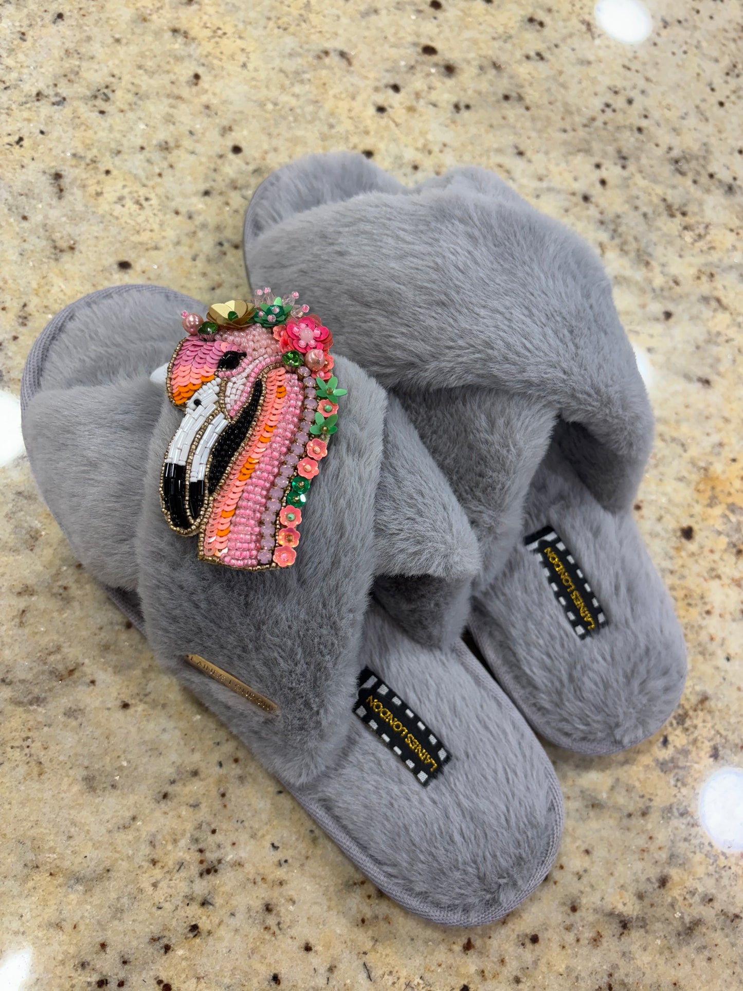 Laines London grey fluffy slippers with flamingo brooch