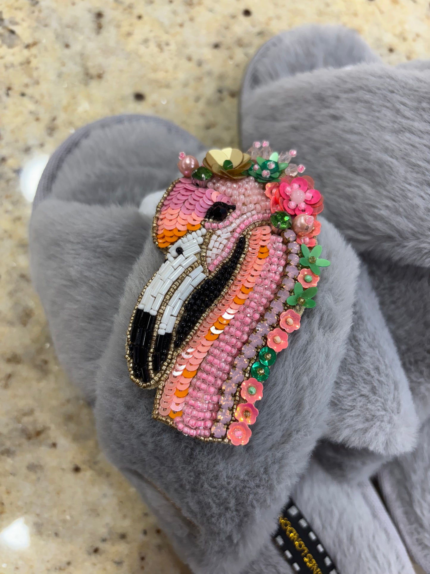 Laines London grey fluffy slippers with flamingo brooch