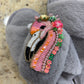 Laines London grey fluffy slippers with flamingo brooch