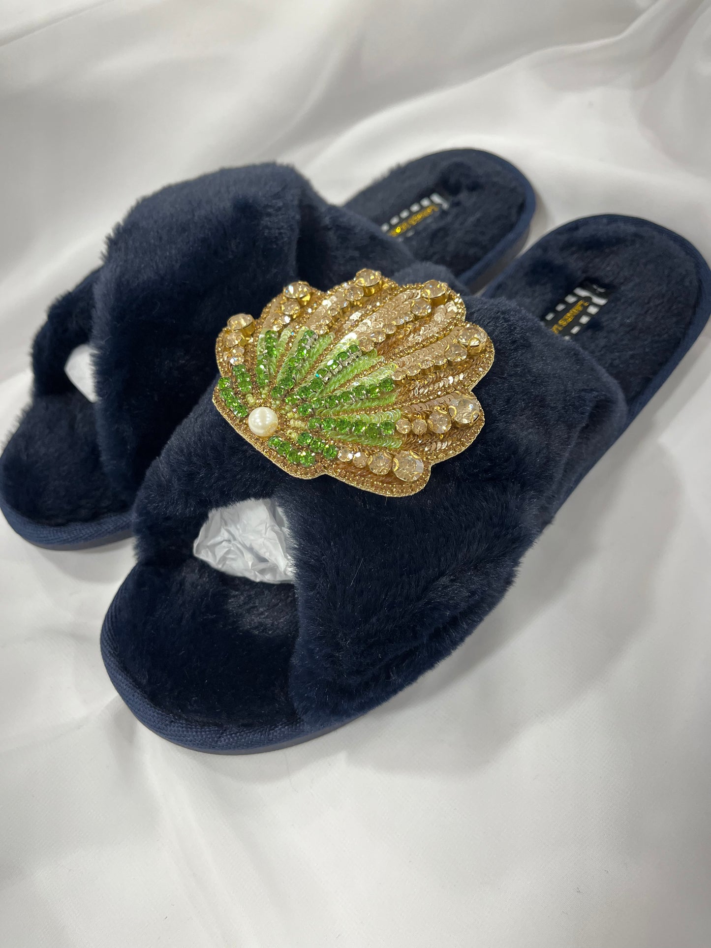 Laines London navy fluffy slippers with green and gold seashell brooch