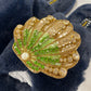 Laines London navy fluffy slippers with green and gold seashell brooch