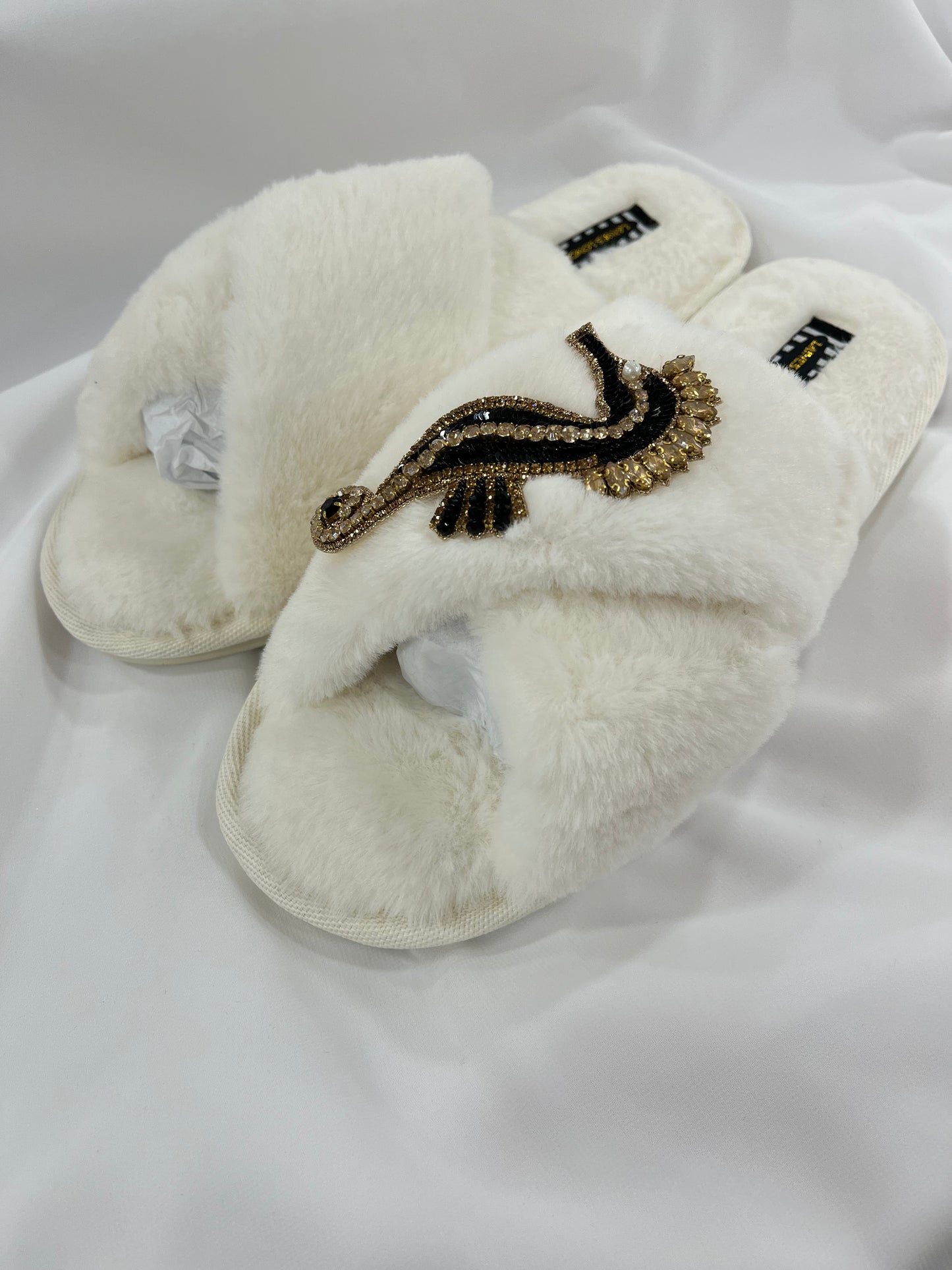 Laines London cream fluffy slippers with black and gold seahorse