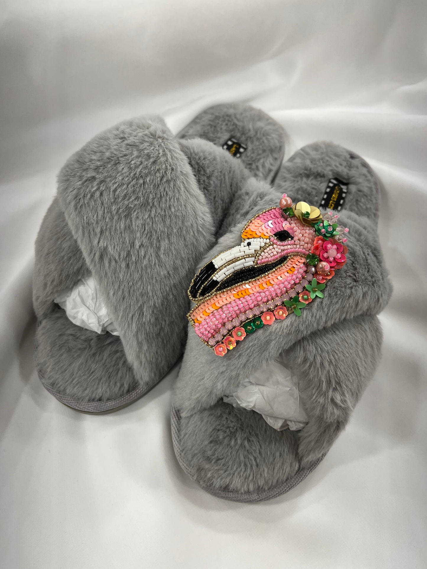 Laines London grey fluffy slippers with pink flamingo brooch