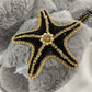 Laines London grey fluffy slippers with black and gold starfish